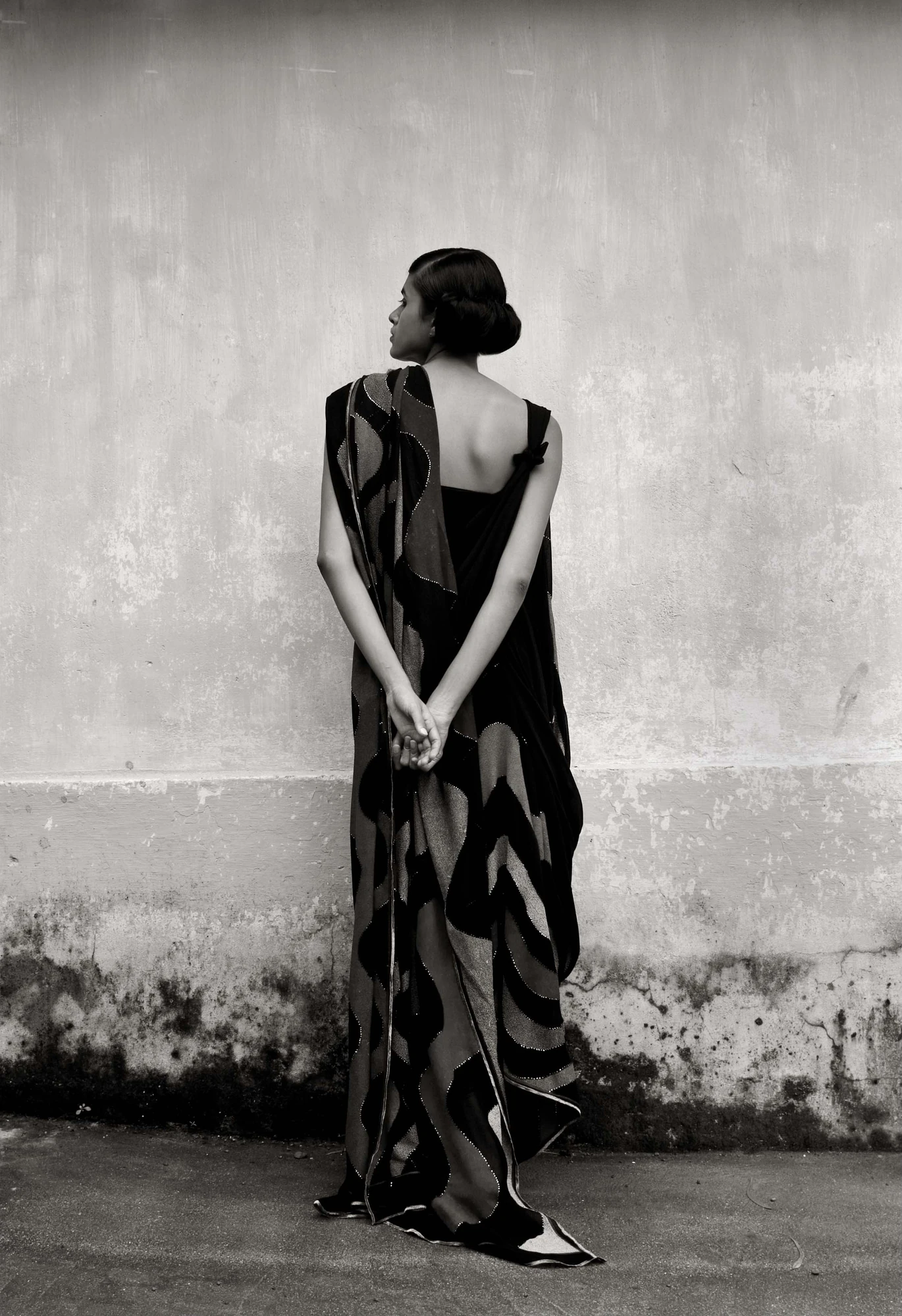 A black and white portrait in a printed silk saree