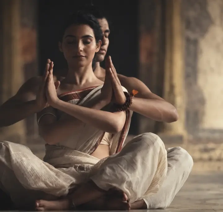 Two dancers seated in meditation